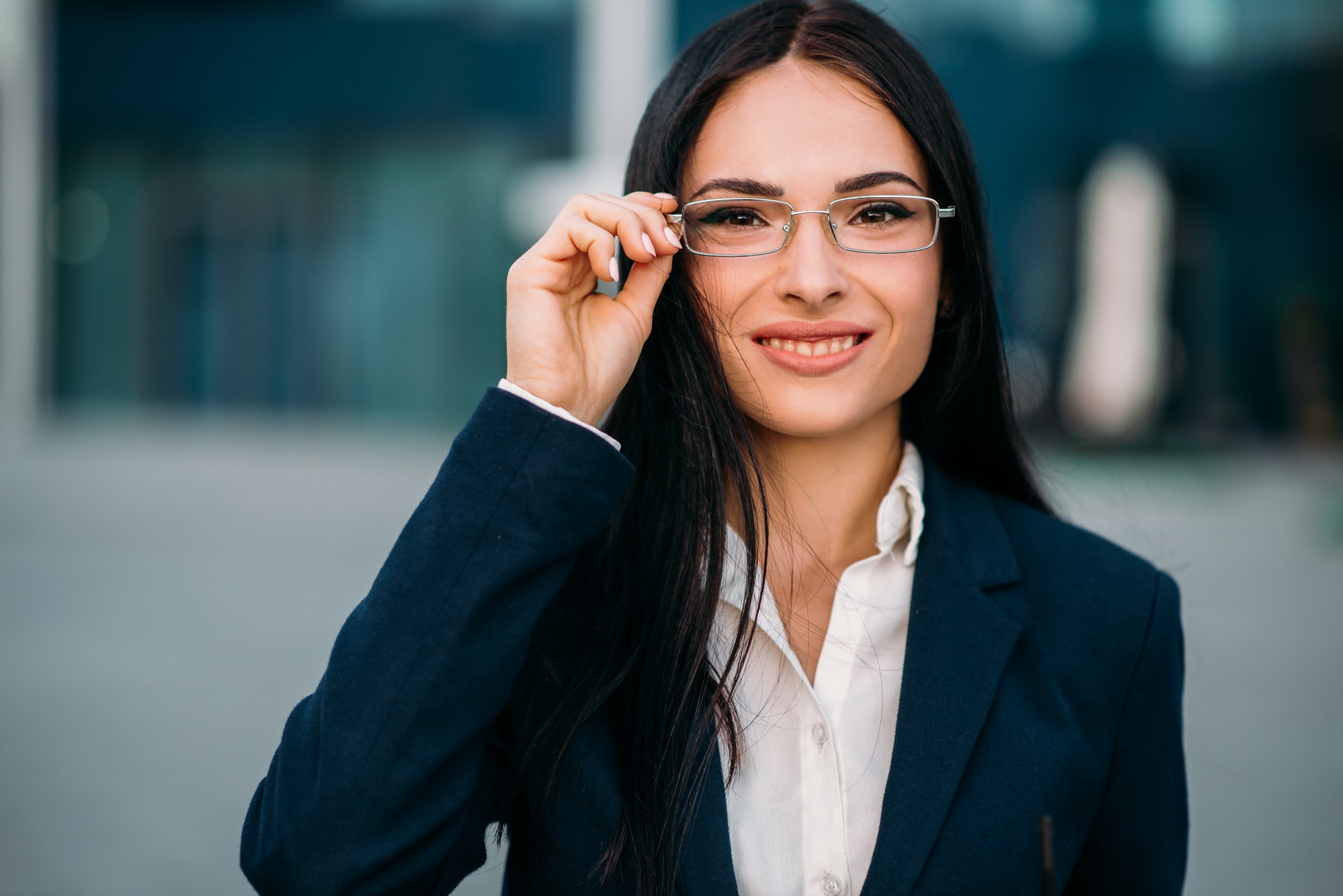 Portrait of business woman in glasses and suit